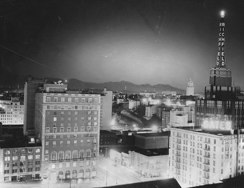 From the Herald-Examiner, dated March 7, 1955. "This is another version of how the atomic bomb blast in Nevada looked over Los Angeles from the roof of the Statler Hotel. Note the sharpness of City Hall (right background), the Richfield Building (right foreground) and other buildings. The crest of the mountains is also clearly delineated."